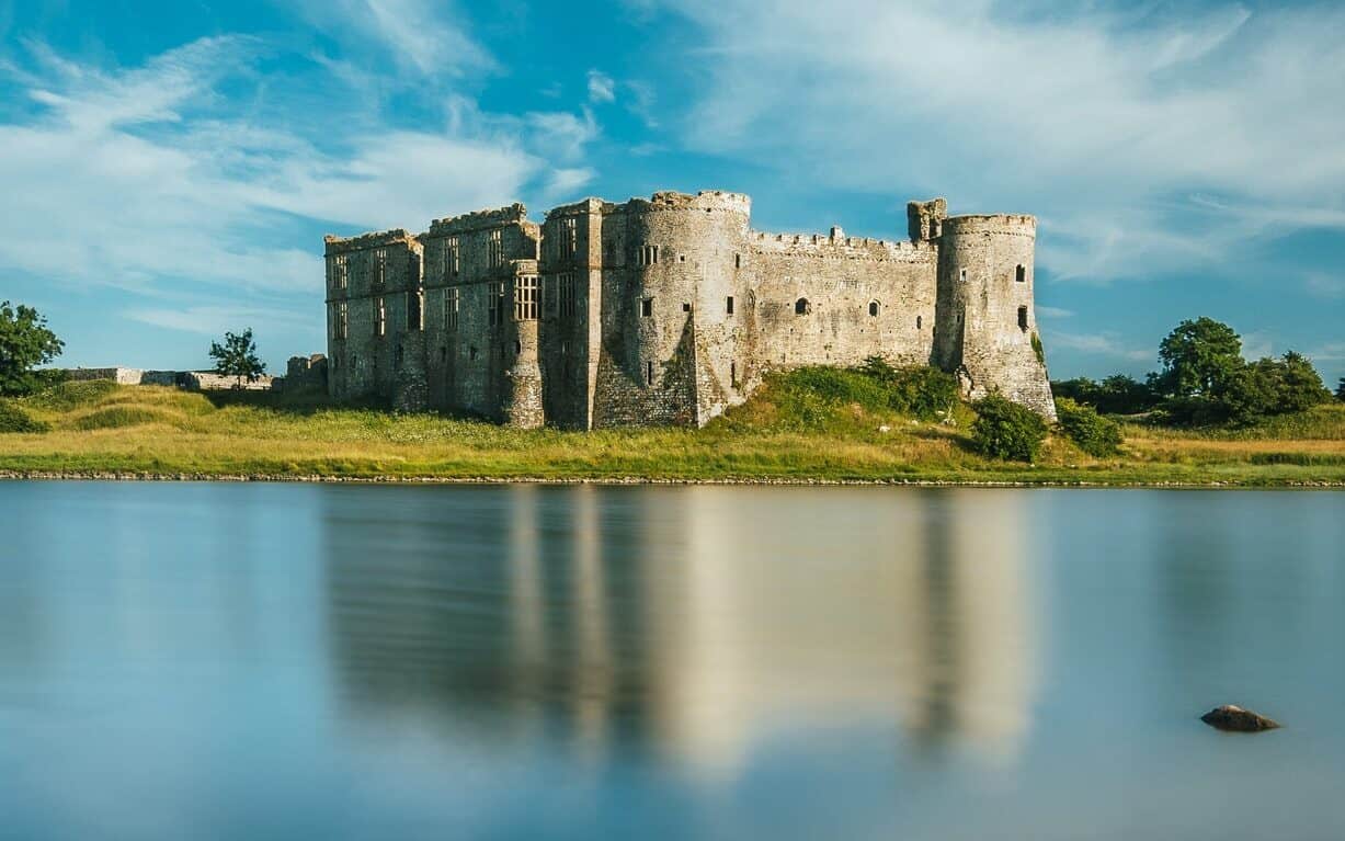  A stunning millpond before a neglected Carew castle ruin in Wales.