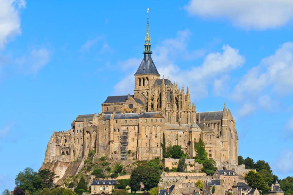 The impressive collection of fortified buildings on Mont Saint-Michel on a clear, blue, sunny day. 