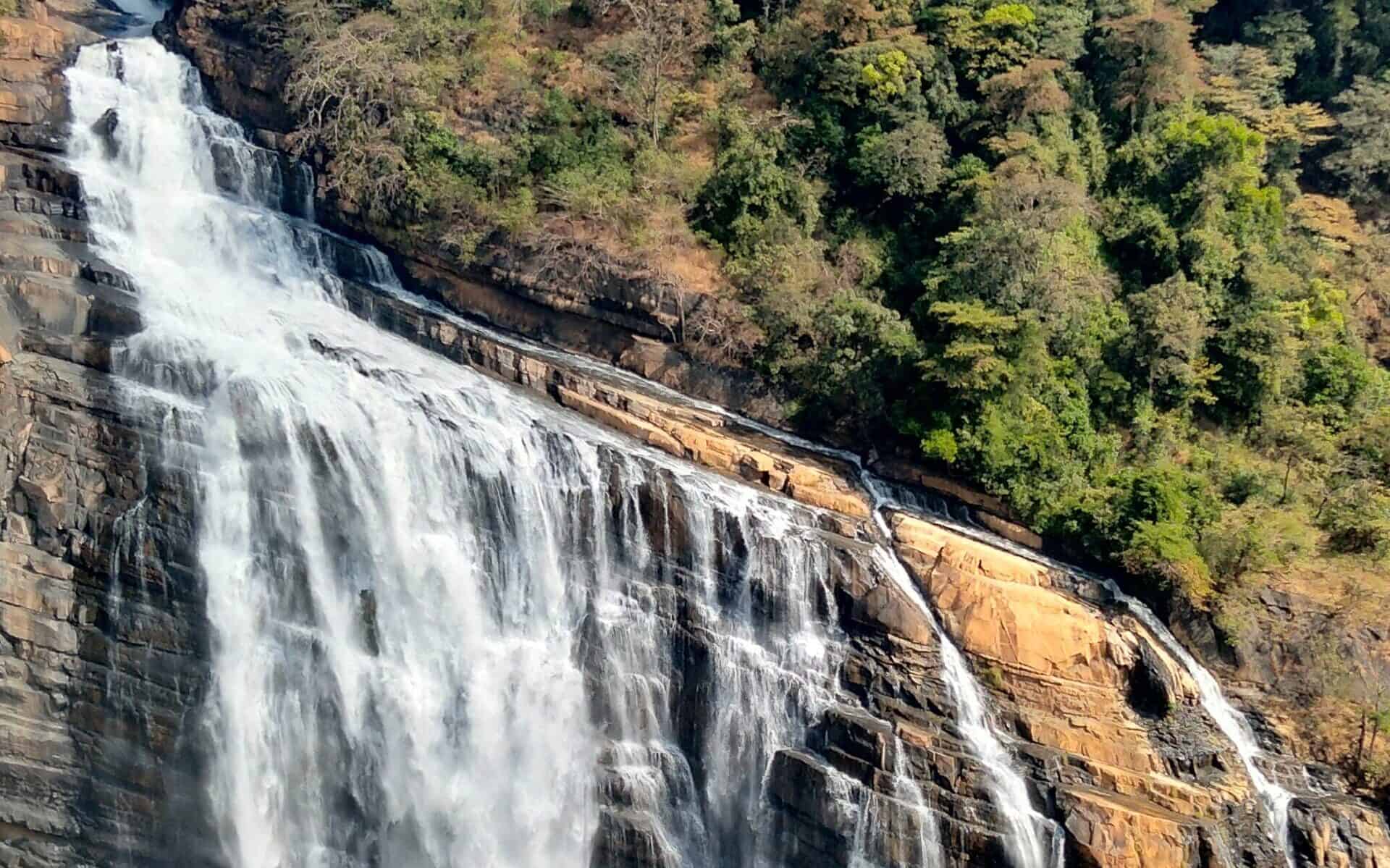Powerful stream of water flows over the unusual mountainous shape of the Unchalli fall in India.